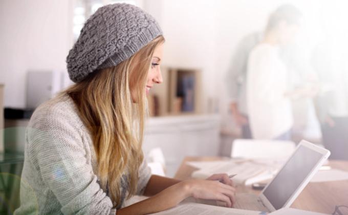 Woman working at a desk on her laptop