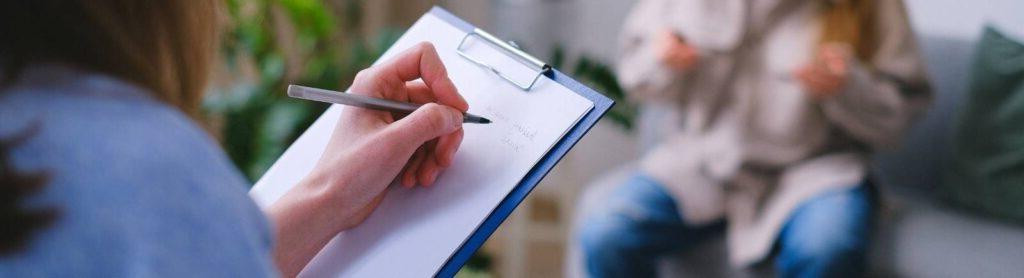 woman holding clipboard to arrange next meeting