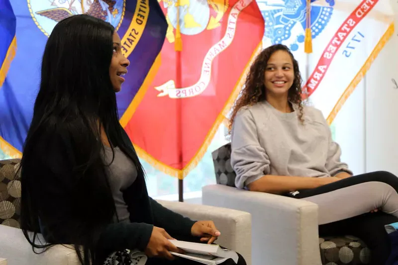 Two female students talking in the Veterans Lounge